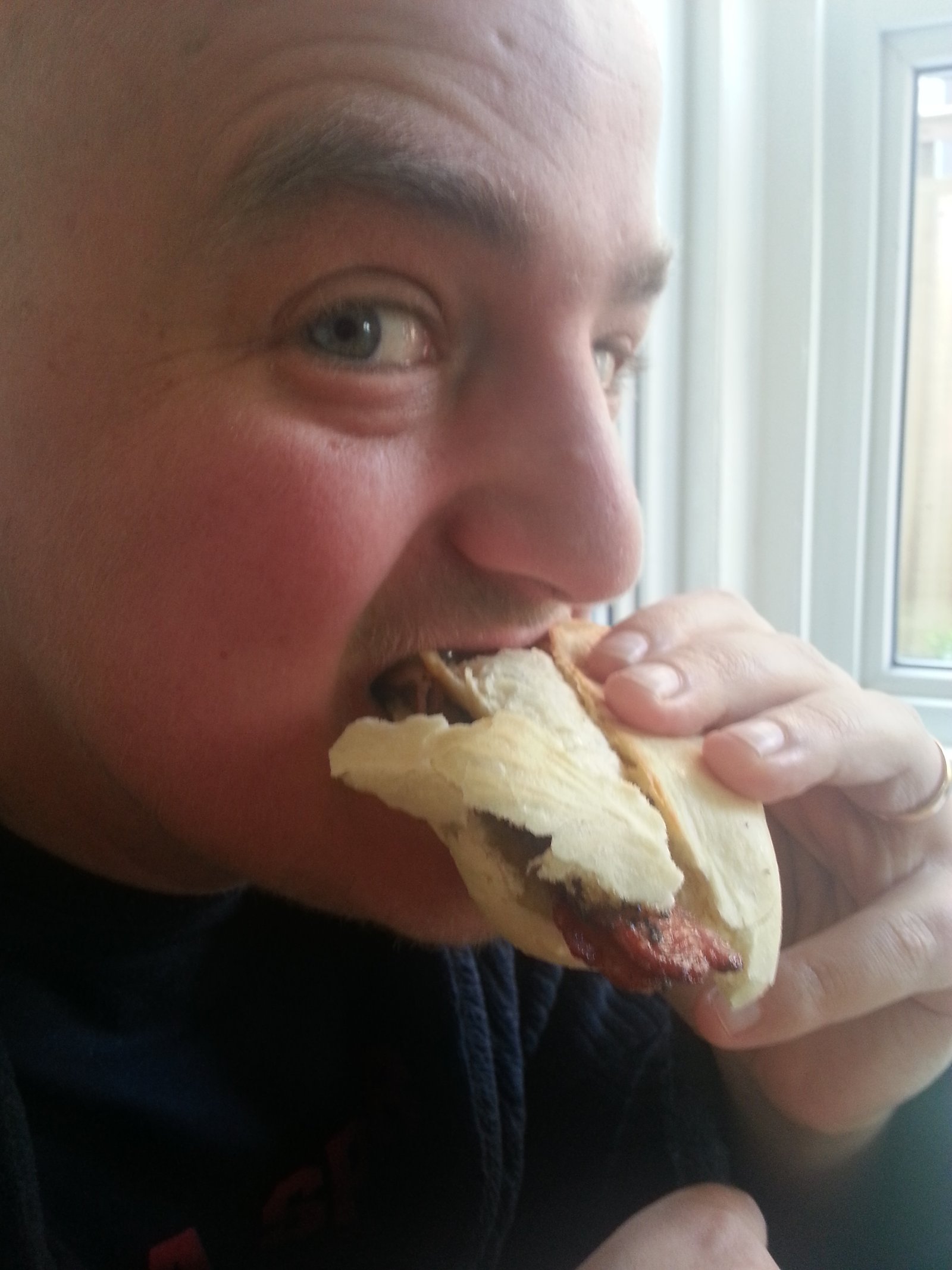 George eating a bacon sandwich