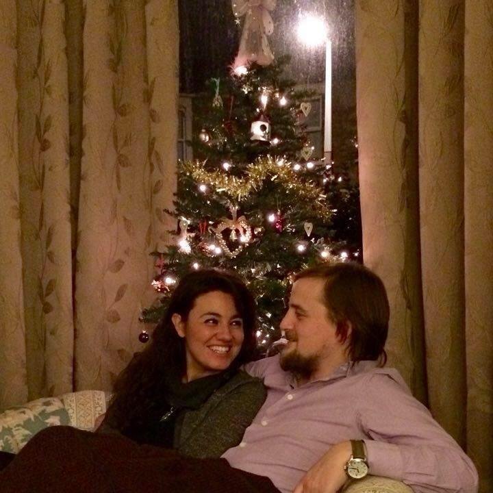 George and Mariacristina in front of a Christmas tree