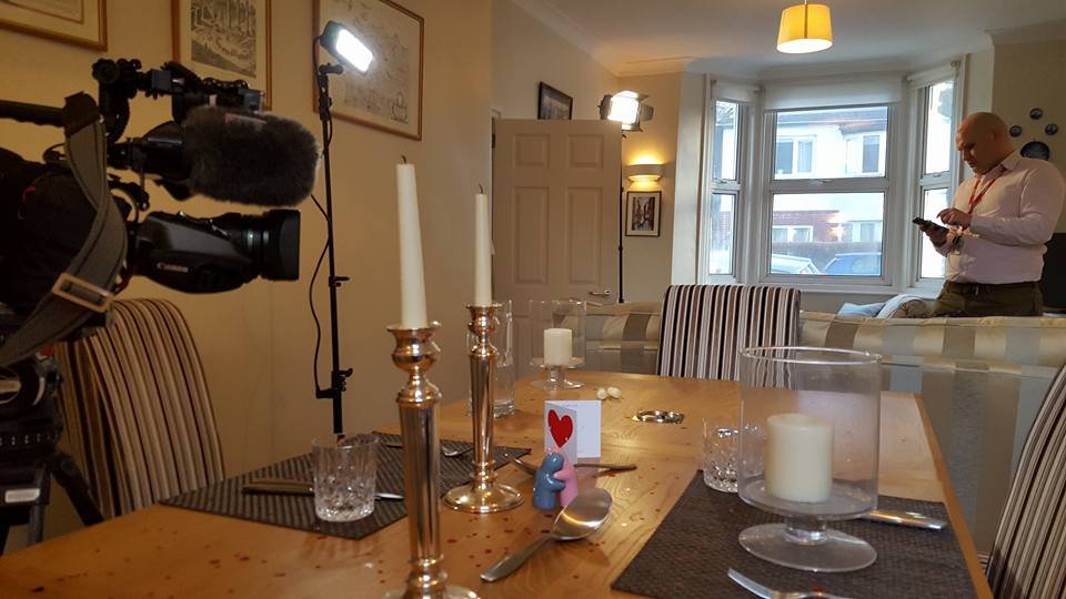 George's dining/living room with BBC crew and romantically laid-out dinner table