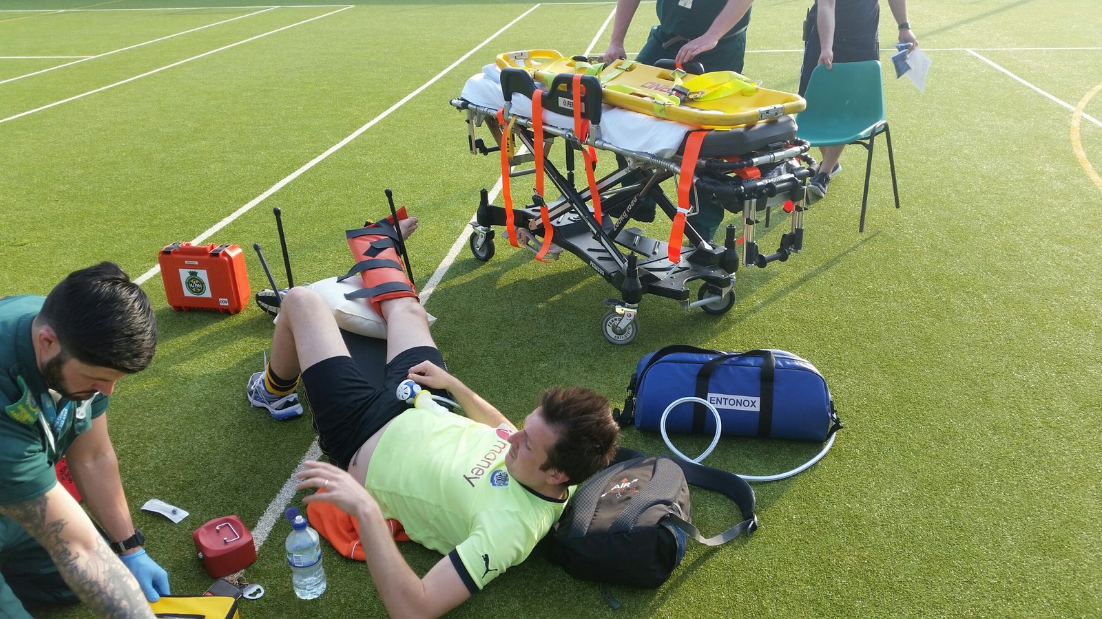 Tim with broken ankle on the football field