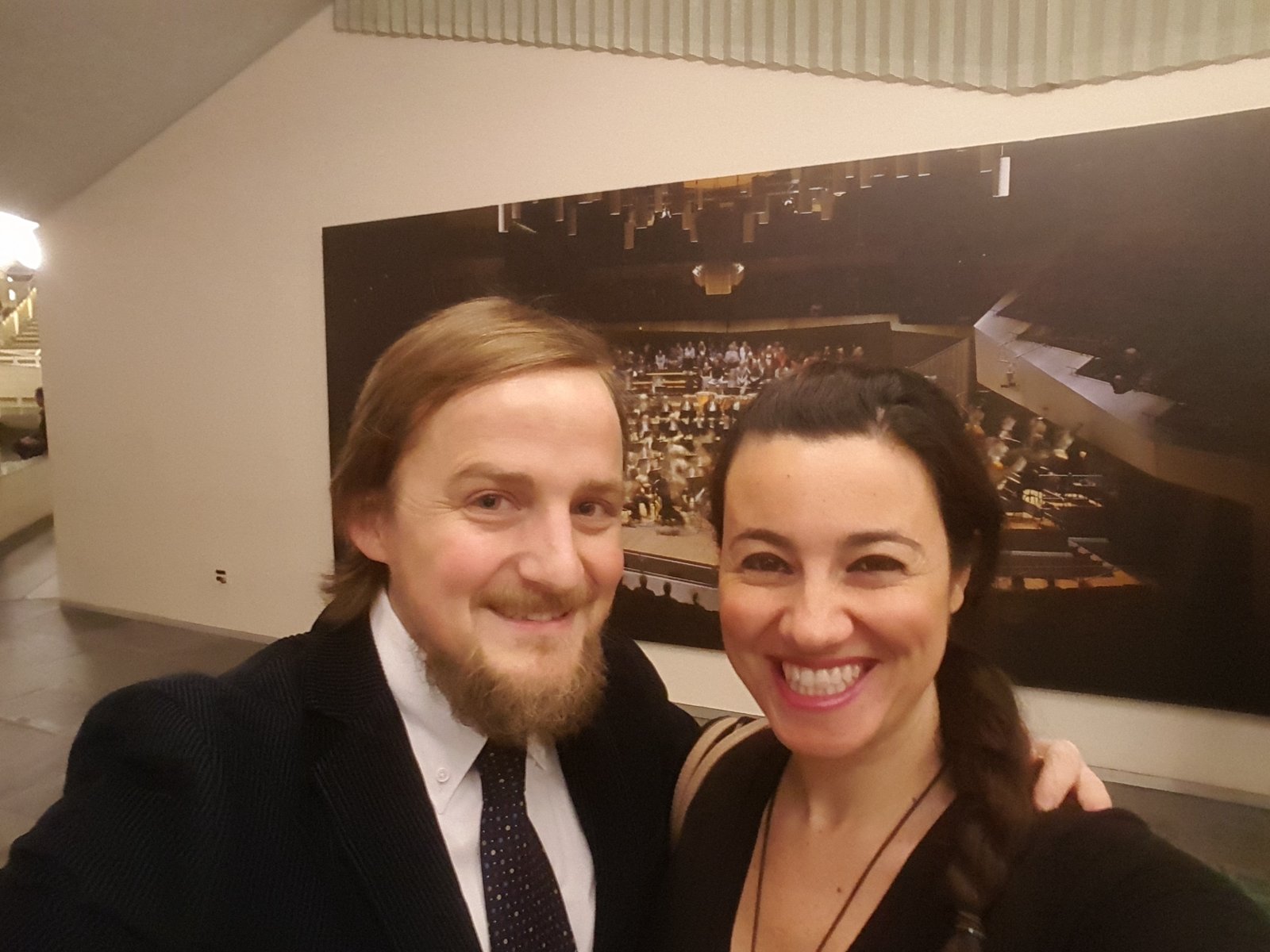 George and Mariacristina looking smart in front of a picture of the Berlin Philharmonic Orchestra