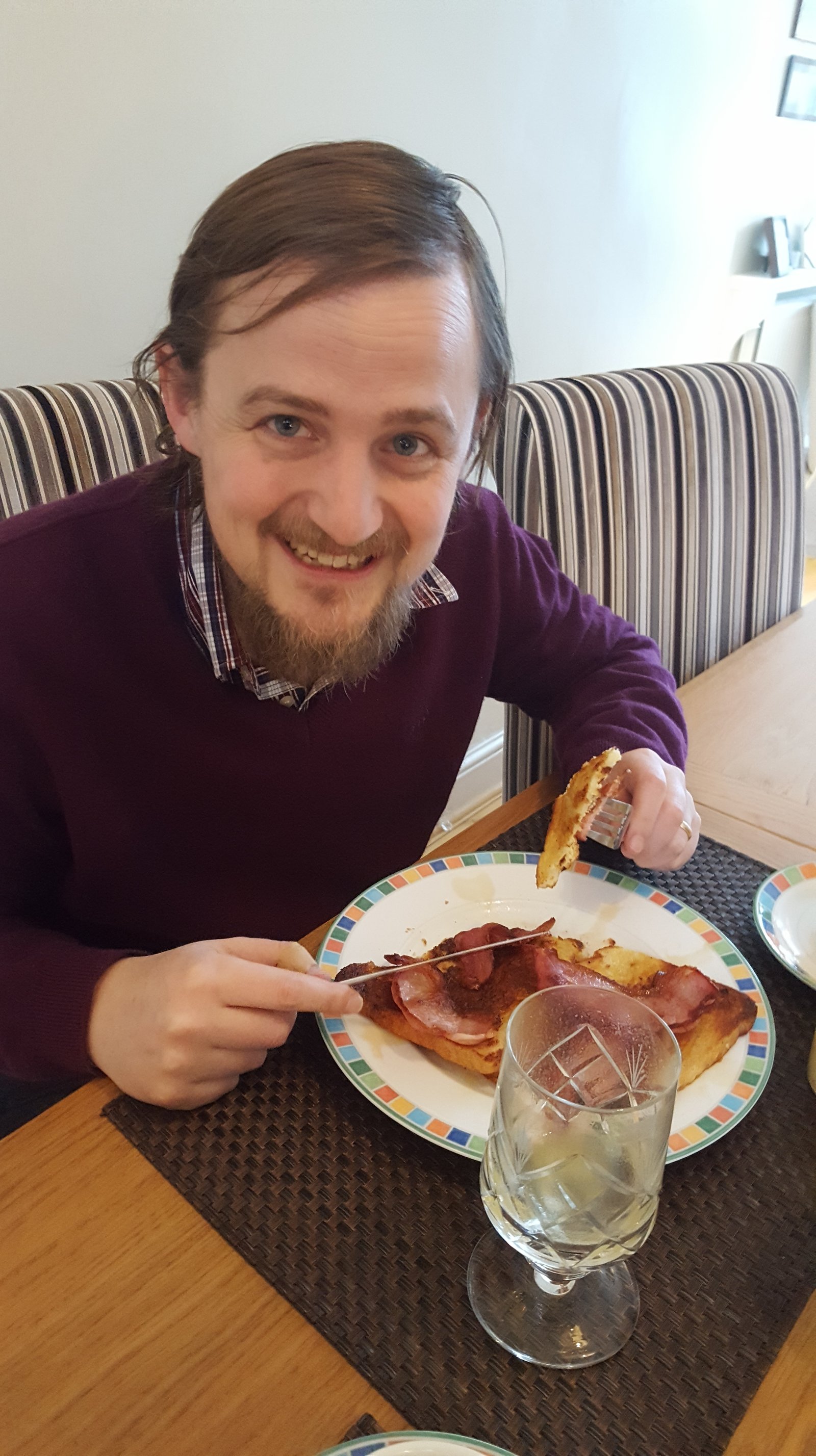 George enjoying bacon and French toast / eggy bread